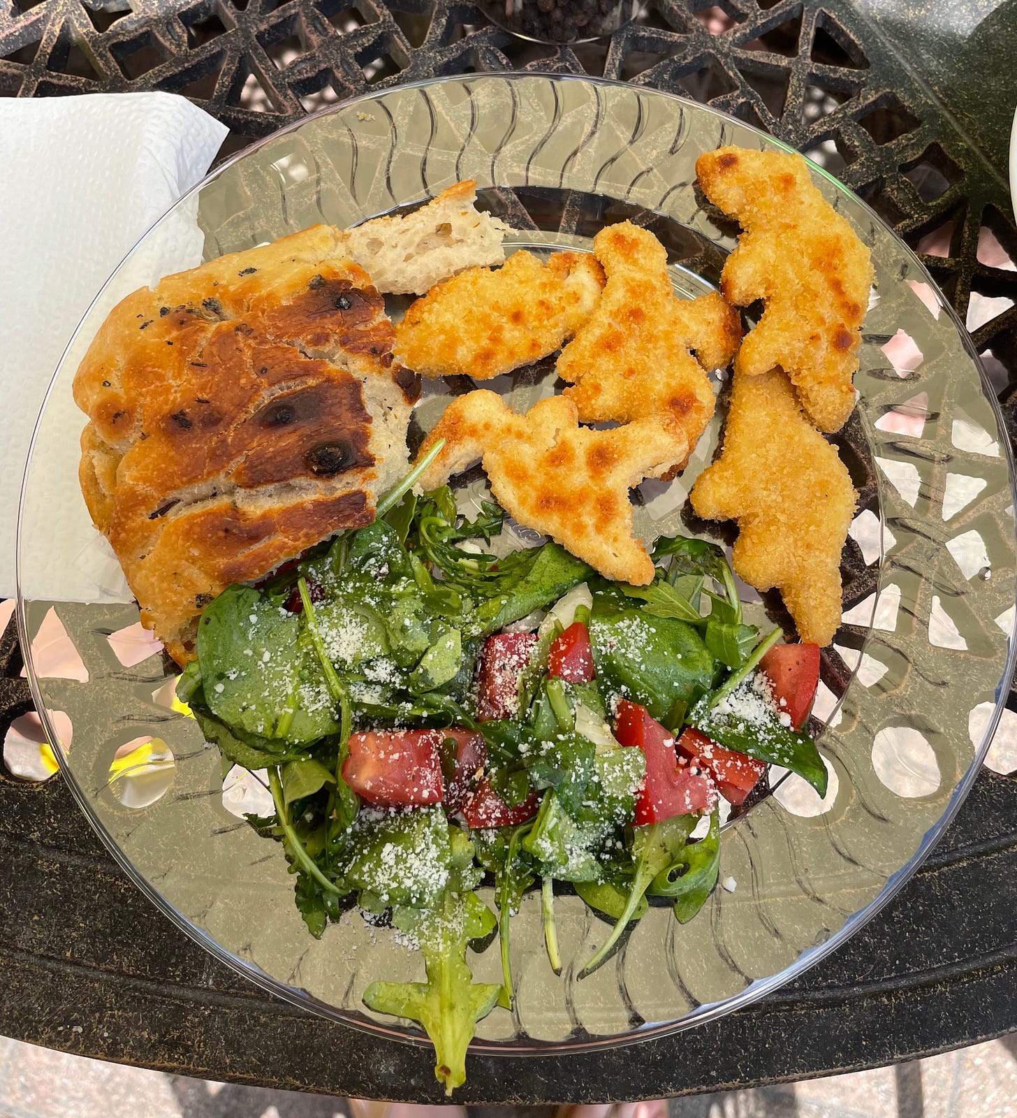 plate with foccacia, dino chicken nuggets, and green salad