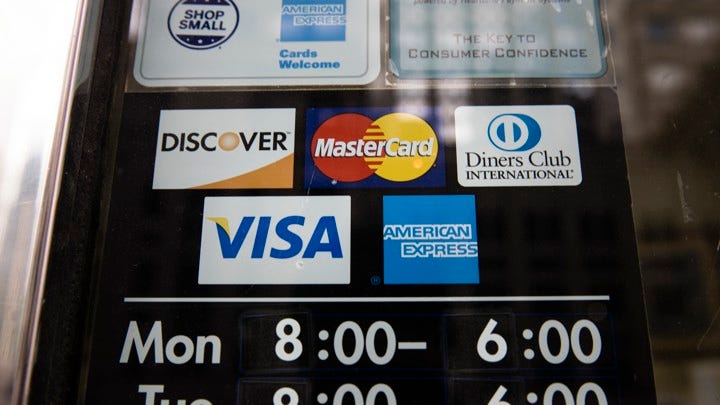 A sign with the logos of various credit-card companies