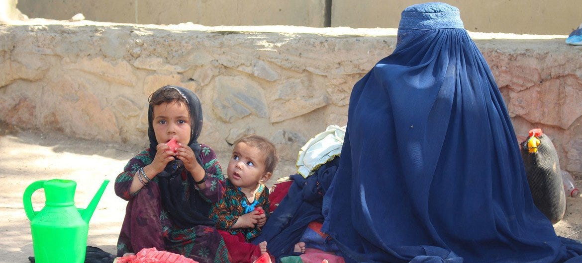 A mother and her children fled conflict in Lashkargah and now live in a displaced persons camp in Kandahar, southern Afghanistan.