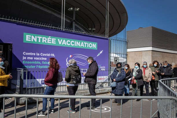 People queue outside the Paris Stade de France following its conversion into a Covid-19 vaccination centre, on April 7, 2021 in Saint-Denis, France.