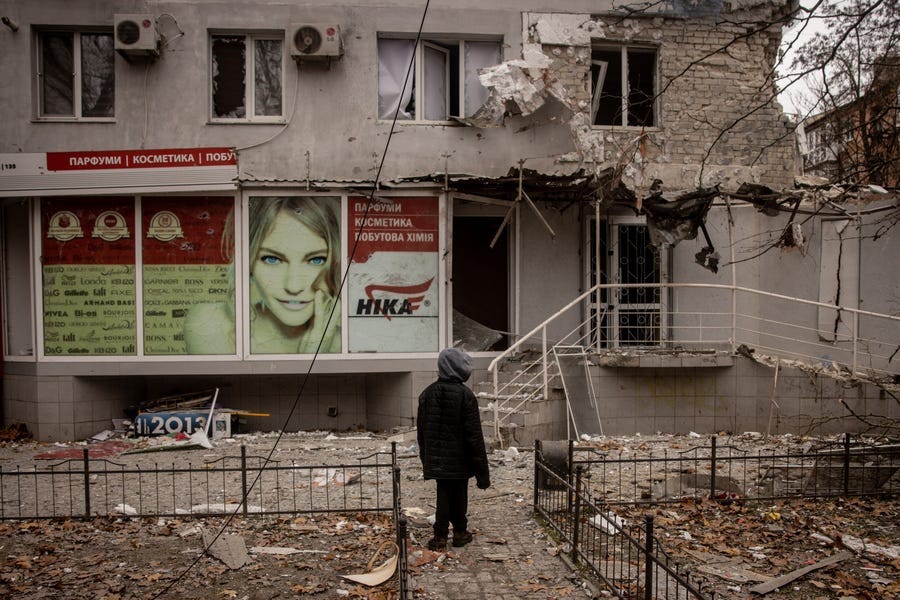A boy looks at damaged caused by overnight Russian shelling of a residential building on December 01, 2022 in Kherson, Ukraine. Recently Ukrainian forces took back control of Kherson, as well as swaths of its surrounding region, after Russia pulled its forces back to the other side of the Dnipro river.