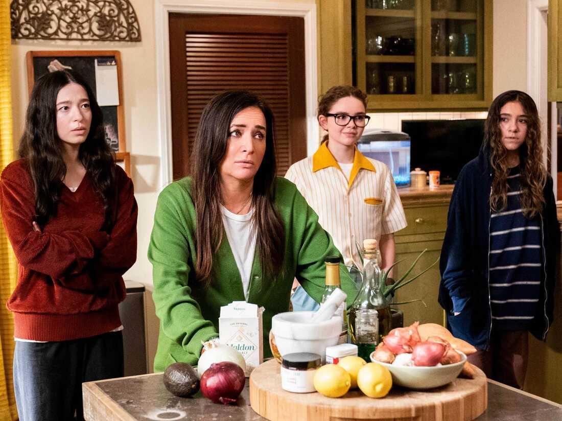 Standing around a kitchen counter, Max (Mikey Madison), Sam (Pamela Adlon), Frankie (Hannah Riley), and Duke (Olivia Edwards) in Season 5 of Better Things.