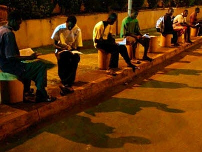 Students studying under the streetlights