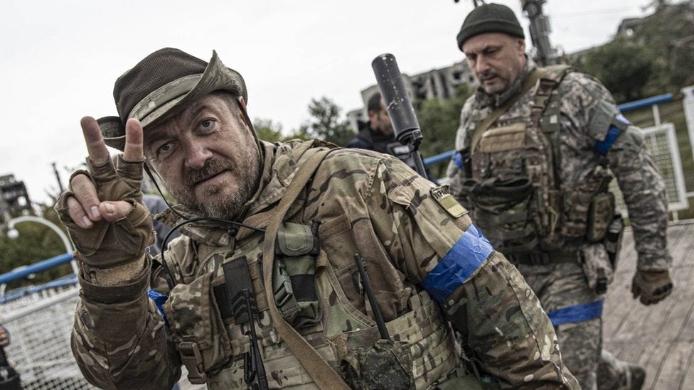 Ukrainian forces show a V sign for victory
