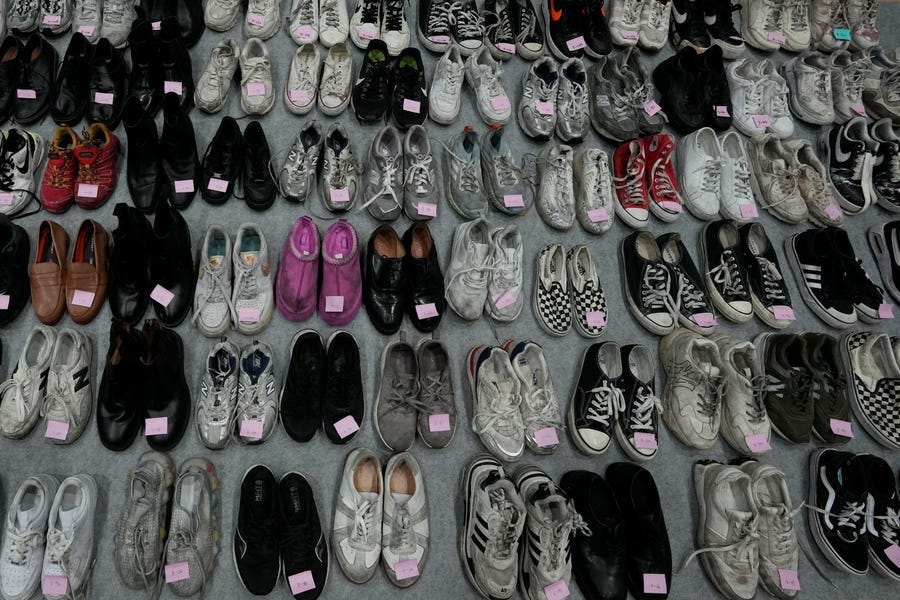 Shoes are seen among a huge collection items found in Itaewon following South Korea’s deadliest crowd surge, at a temporary lost and found center at a gym in Seoul, South Korea, Tuesday, Nov. 1, 2022. Police have assembled the crumpled tennis shoes, loafers and Chuck Taylors, part of 1.5 tons of personal objects left by victims and survivors of the tragedy, in hopes that the owners, or their friends and family, will retrieve them.