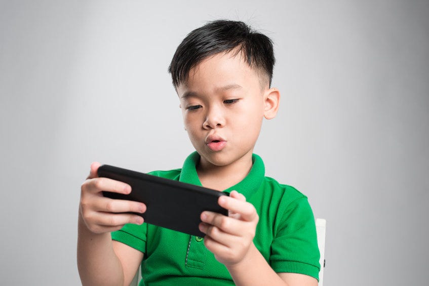Kid playing on a smart phone