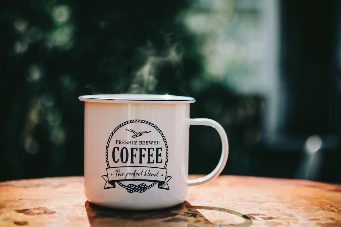 Free White Coffee Mug on Brown Surface Stock Photo