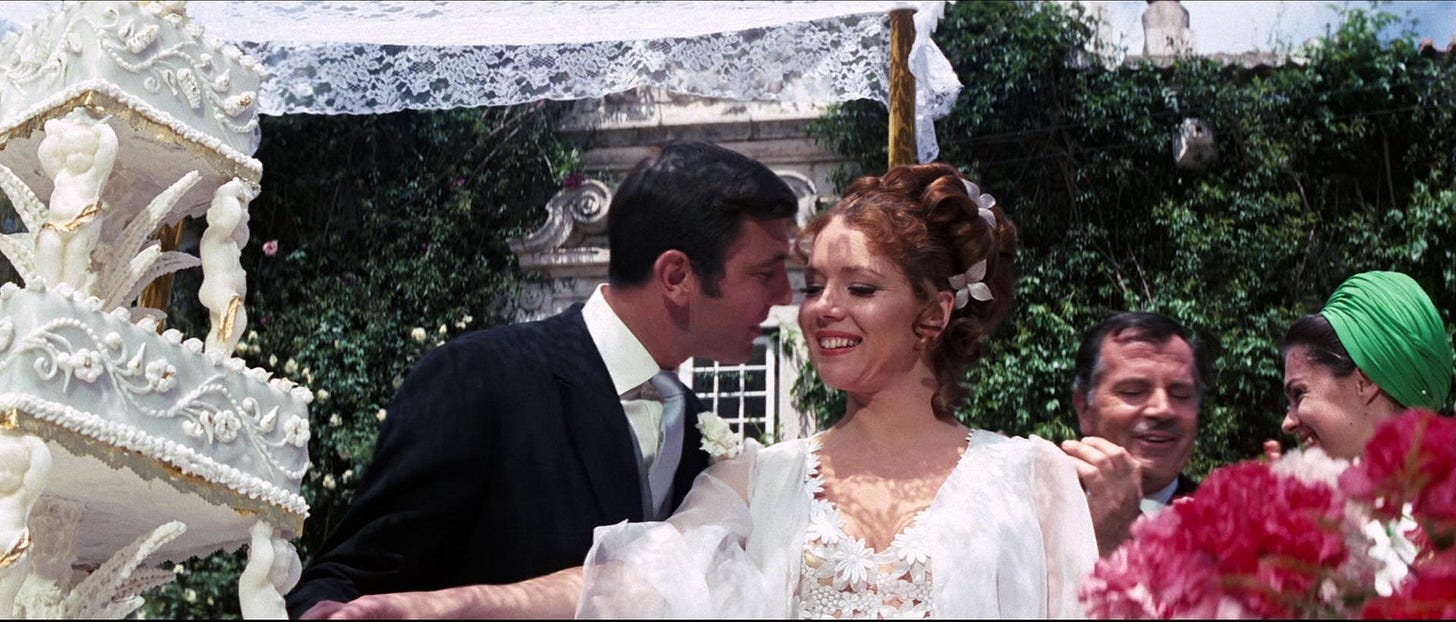 This image shows the wedding of James Bond (played by George Lazenby) and Teresa "Tracy" di Vincenzo (played by Diana Rigg) in 1969's On Her Majesty's Secret Service. Bond looks at the smiling Tracy as she cuts their wedding cake. Tracy's father, Marc-Ange Draco (played by Gabriel Ferzetti) and his assistant Olympe (played by Virginia North) stand to Bond's and Tracy's right. This image shows the wedding of James Bond (played by George Lazenby) and Teresa "Tracy" di Vincenzo (played by Diana Rigg) in 1969's On Her Majesty's Secret Service. Bond looks at the smiling Tracy as she cuts their wedding cake. Tracy's father, Marc-Ange Draco (played by Gabriel Ferzetti) and his assistant Olympe (played by Virginia North) stand to Bond's and Tracy's right.