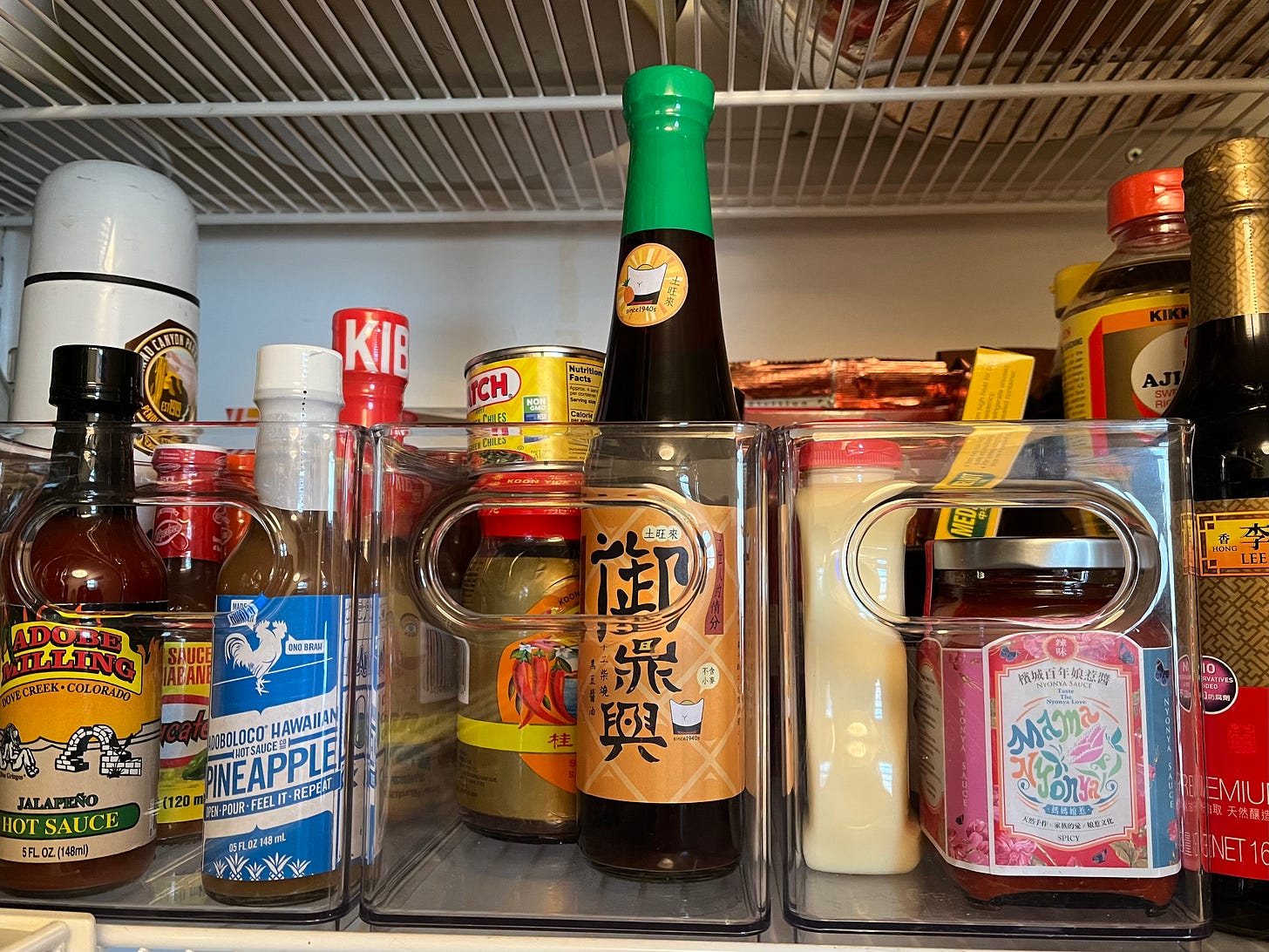 Jars and bottles of sauces on a pantry shelf