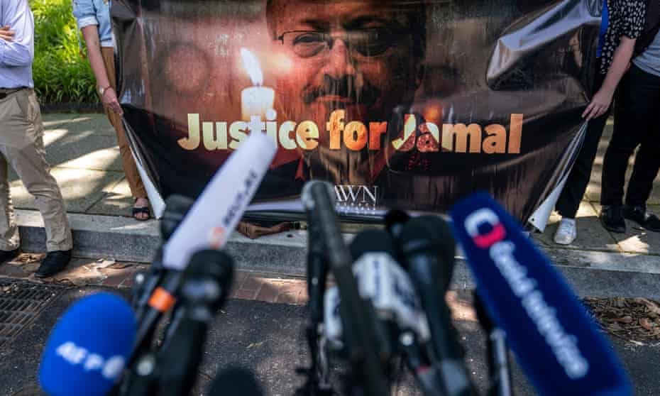 Activists hold a banner showing an image of Jamal Khashoggi with words "Justice for Jamal"