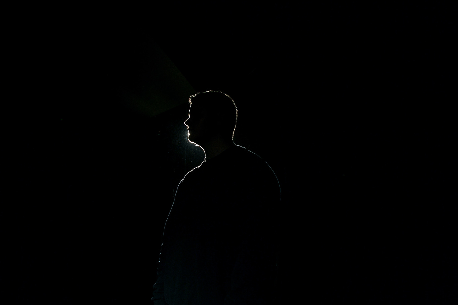 Silhouette of a man plausibly onstage