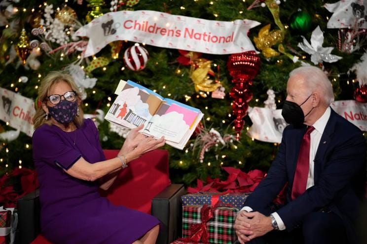 First lady Jill Biden, accompanied by President Joe Biden, reads "The Snowy Day" by Ezra Jack Keats at Children's National Hospital in Washington