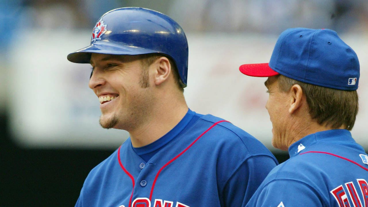 Toronto-Blue-Jays-third-baseman-Eric-Hinske-(11)-smiles-as-he-is-congratulated-by-first-base-coach-John-Gibbons-after-driving-in-the-winning-run-during-eigth-inning-AL-action-against-the-Detroit-Tigers-in-Toronto-on-Sunday-Sept.-29,-2002.-(Frank-Gunn/CP)