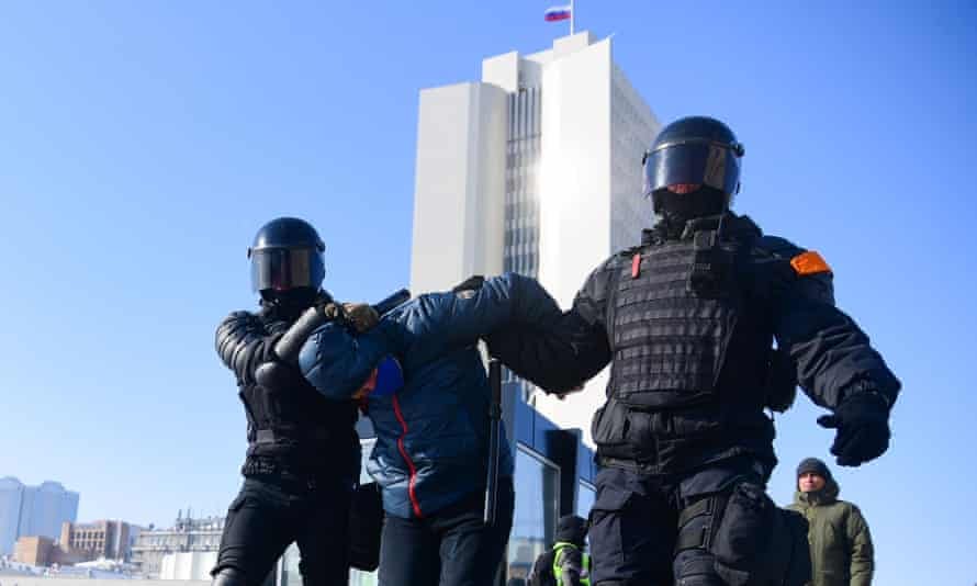 Riot police detain a man during a rally in support of the jailed opposition leader Alexei Navalny