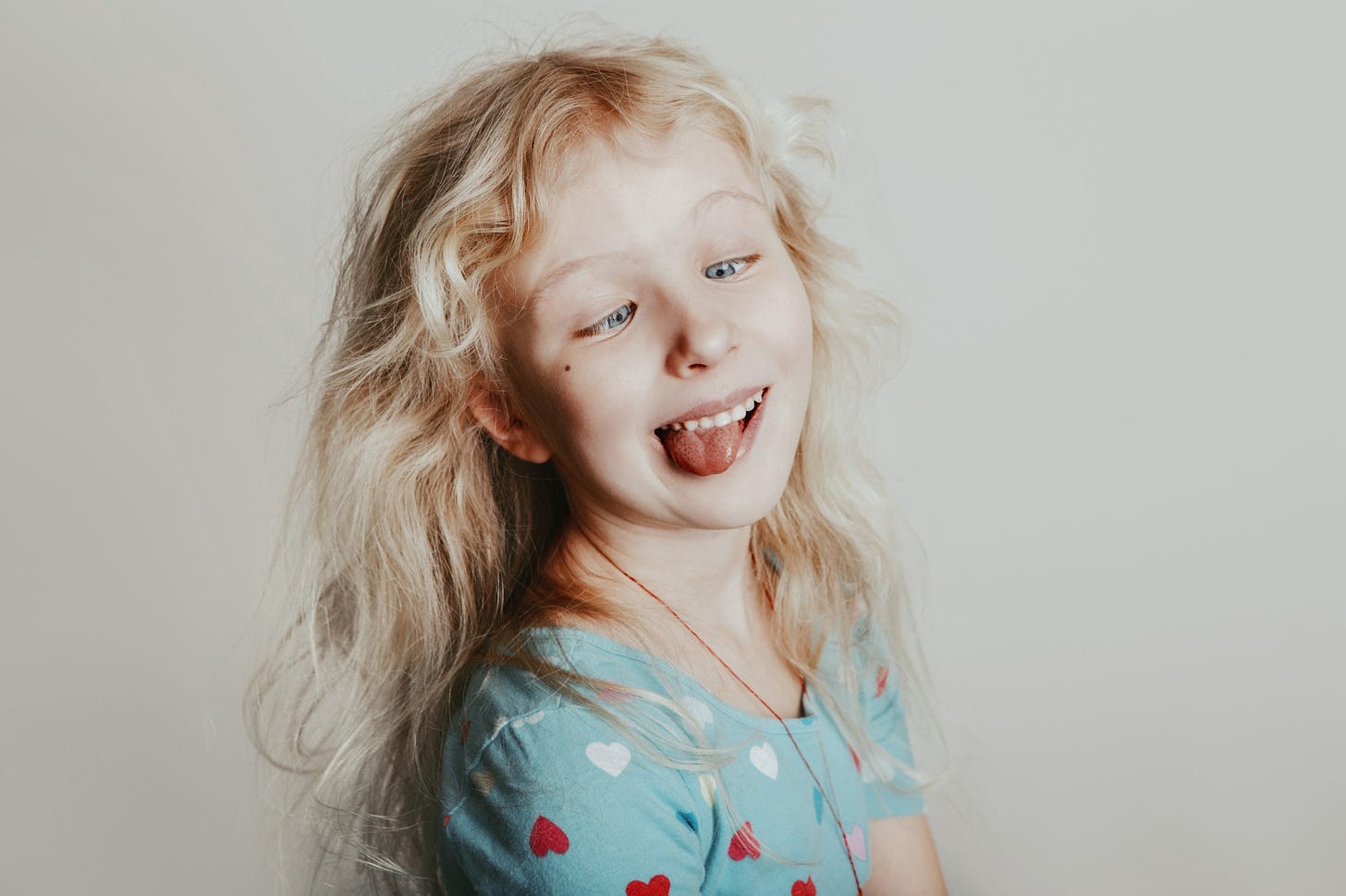 A blond girl pulls a silly face at the camera.