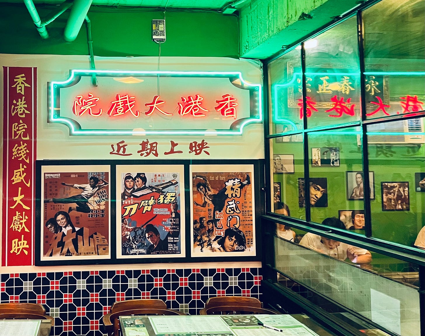Green and red neon lights and Bruce Lee posters decorate the walls of Boji HK Style Restaurant in Taipei's Da'an District