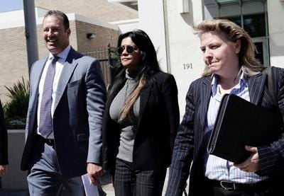 Amy Pinto-Walsh (center) walks out of Santa Clara County Superior Court with her attorneys, Douglas Dal Cielo (l) and Sonia Agee following a hearing in San Jose, Calif. on Tuesday, June 12, 2012. Pinto-Walsh is at the center of a battle over world famous artist Thomas Kinkade's estate following his death earlier this year.  (Gary Reyes/ Staff)