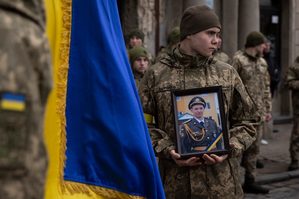 A joint funeral takes place at 'Saint's Peter and Paul Garrison Church', for two soldiers who died in the east of the country during recent fighting.