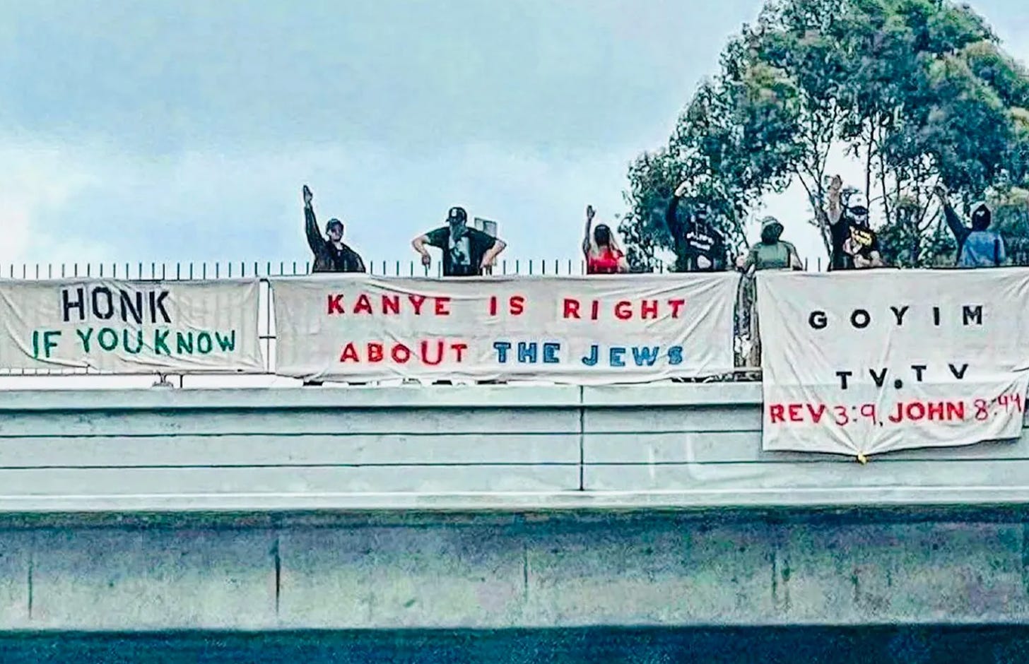 "Kanye is right about the jews" on a banner while peope give the heil hitler salute