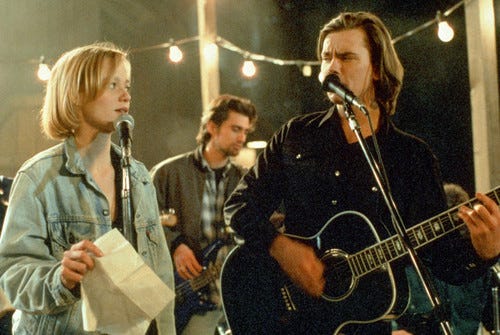 Image Credit: The Thing Called Love, 1993, depicting Samantha Mathis and River Phoenix performing a song onstage and looking fine as hell