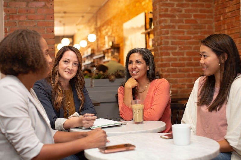 Women talking around a table