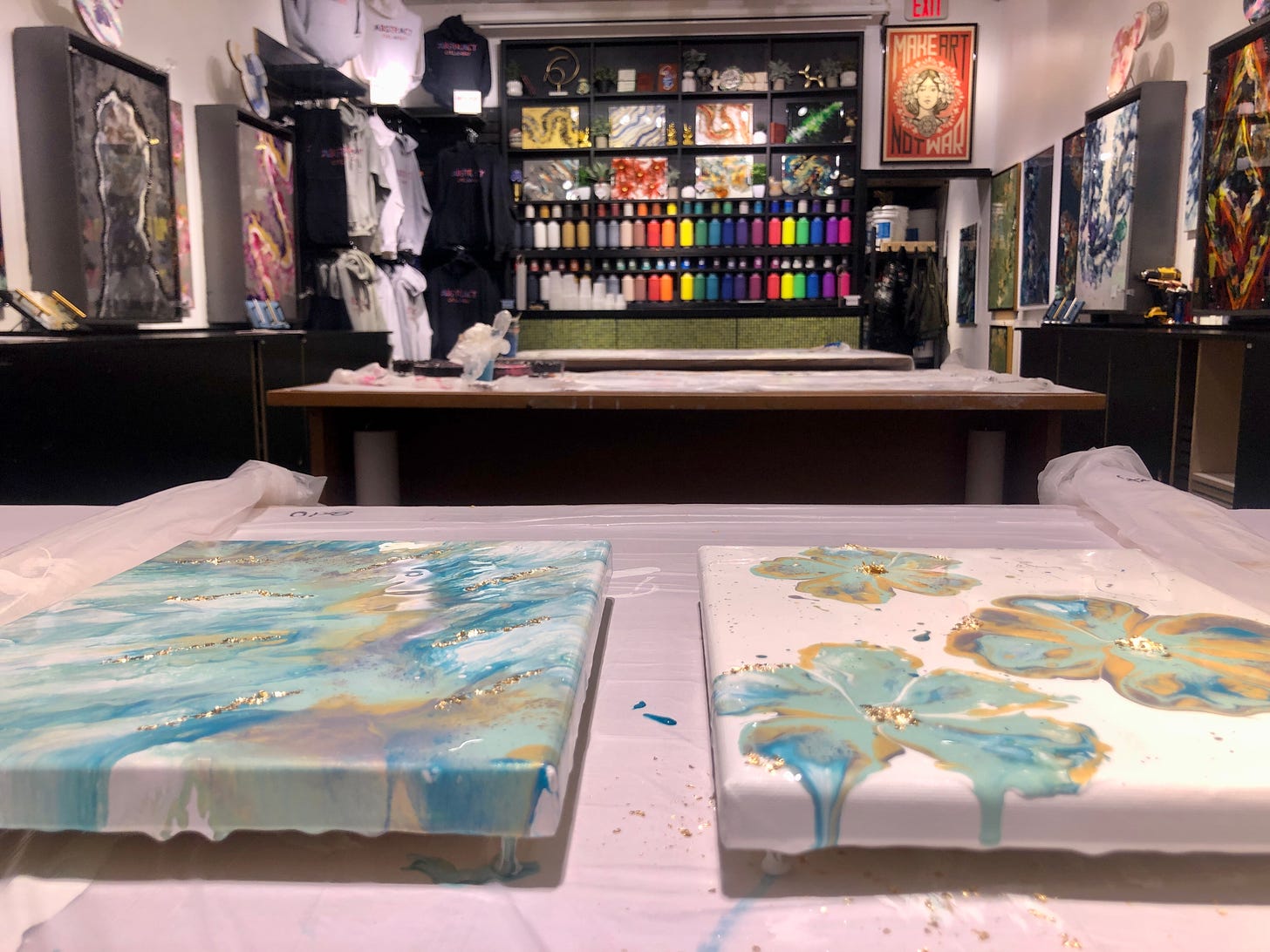Fluid art studio with two finished projects.