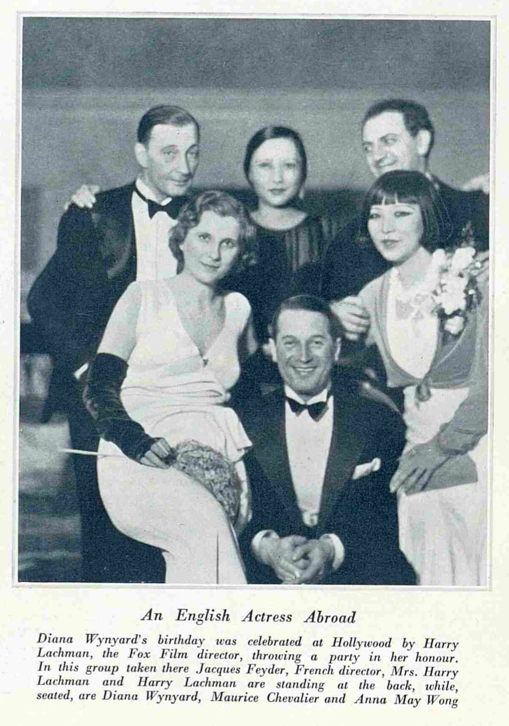 clipping from The Bystander, black and white photo of the Lachmans, Diana Wynyard, and other guests at a party