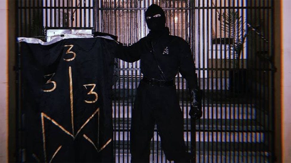 Masked man posing with ONA symbols