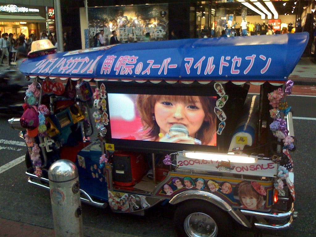 A tuk-tuk with a TV