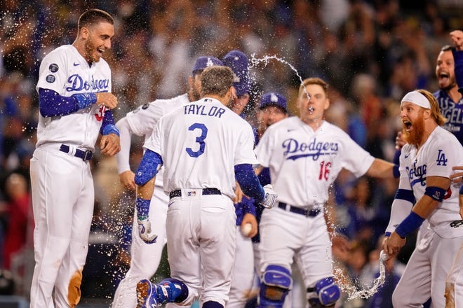 The Dodgers celebrate the walk-off two run home run hit by left fielder Chris Taylor in the ninth inning.