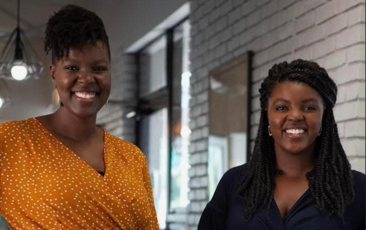 Deborah Gladney and Angela Muhwezi-Hall stand smiling to the camera.