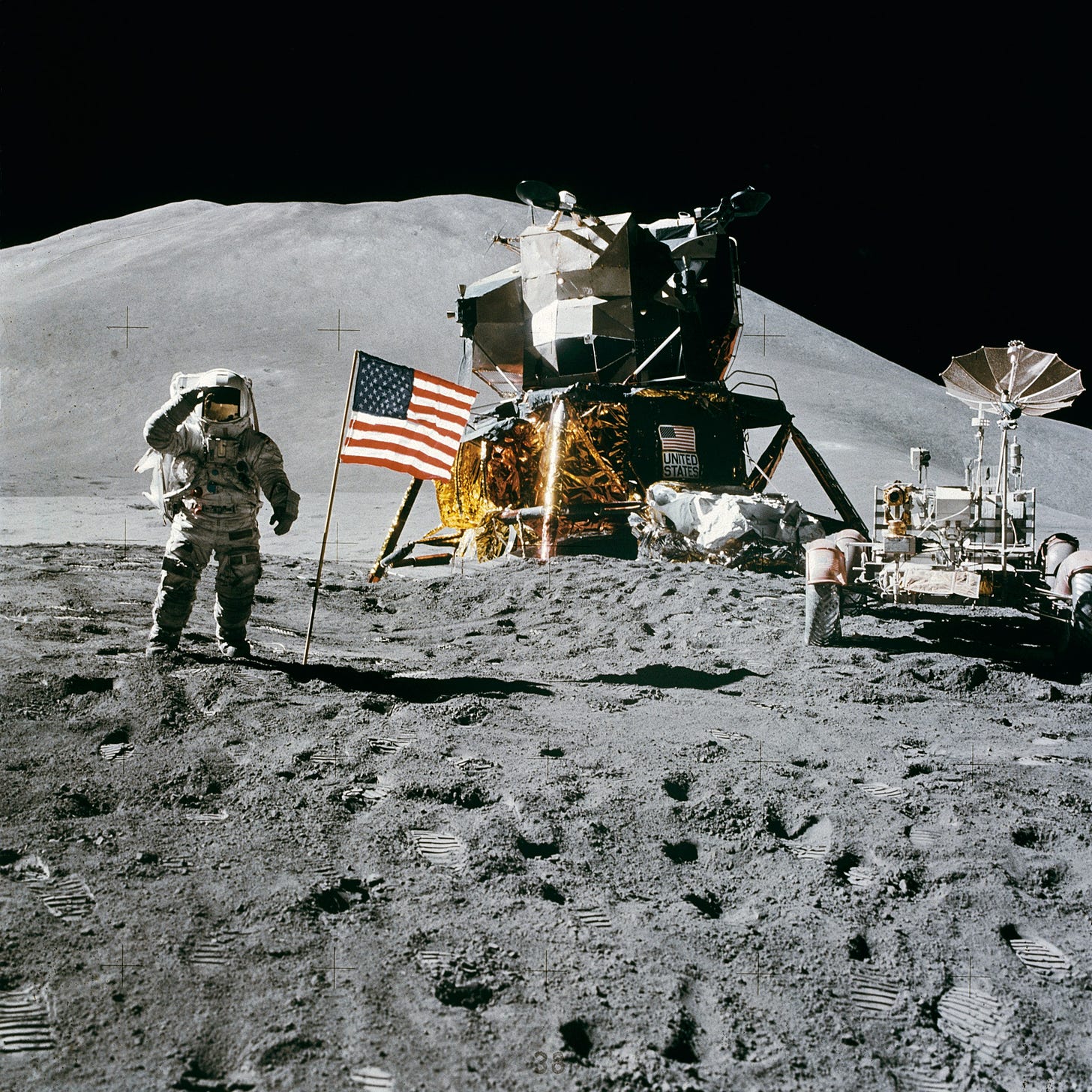 NASA description: Astronaut James B. Irwin, lunar module pilot, gives a military salute while standing beside the deployed U.S. flag during the Apollo 15 lunar surface extravehicular activity (EVA) at the Hadley-Apennine landing site. The flag was deployed toward the end of EVA-2. The Lunar Module (LM) "Falcon" is in the center. On the right is the Lunar Roving Vehicle (LRV). This view is looking almost due south. Hadley Delta in the background rises approximately 4,000 meters (about 13,124 feet) above the plain. The base of the mountain is approximately 5 kilometers (about 3 statute miles) away. This photograph was taken by Astronaut David R. Scott, Apollo 15 commander.