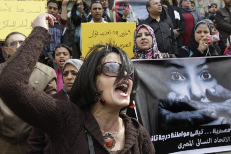 Egyptian female protester hold posters and shout slogans.s