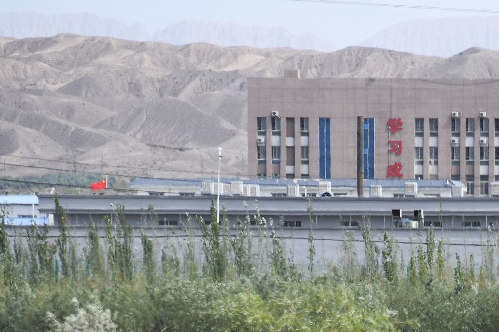  Artux City Vocational Skills Education Training Service Center, believed to be a re-education camp where mostly Muslim ethnic minorities are detained, north of Kashgar in China's northwestern Xinjiang region. - As many as one million ethnic Uighurs and other mostly Muslim minorities are believed to be held in a network of internment camps in Xinjiang, but China has not given any figures and describes the facilities as "vocational education centres" aimed at steering people away from extremism. The top two characters on the building at R read "Study". (Photo by GREG BAKER / AFP) / TO GO WITH China-Xinjiang-media-rights-press,FOCUS by Eva XIAO (Photo credit should read GREG BAKER/AFP via Getty Images)