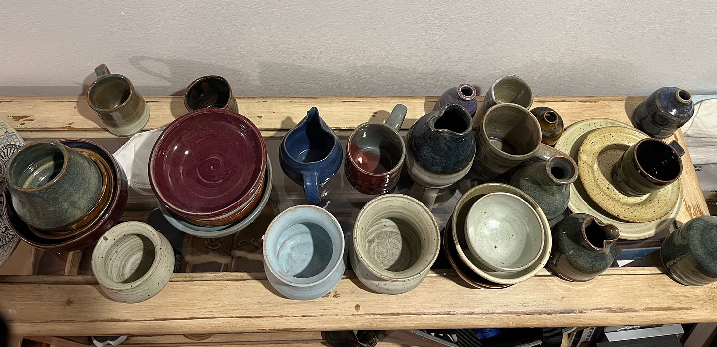 many pieces of lumpy pottery of various sizes and shapes