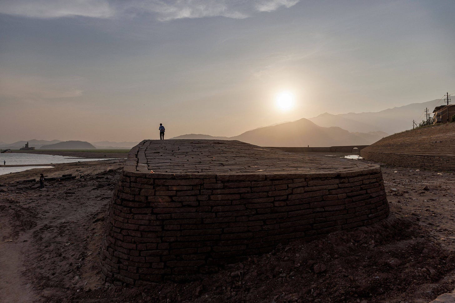 A person walks on the embankment of Poyang Lake, which exhibits low water levels because of a regional drought in Lushan, Jiangxi province, China, on Aug. 24. (Thomas Peter/Reuters)