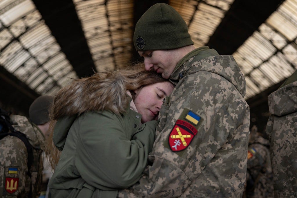 A couple shares a heartwarming moment before the military departure.