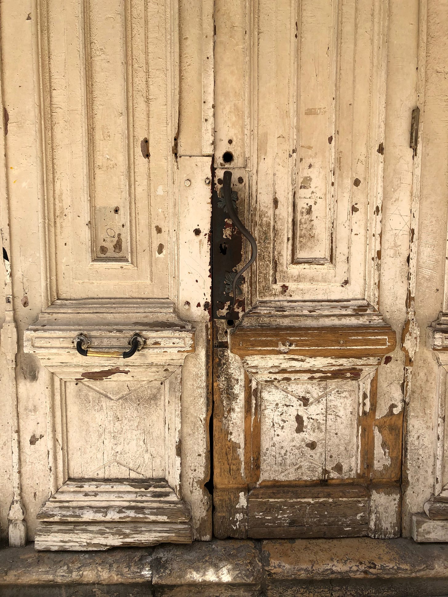 Image of an old, battered wooden door with chipped paint and lots of stories to tell