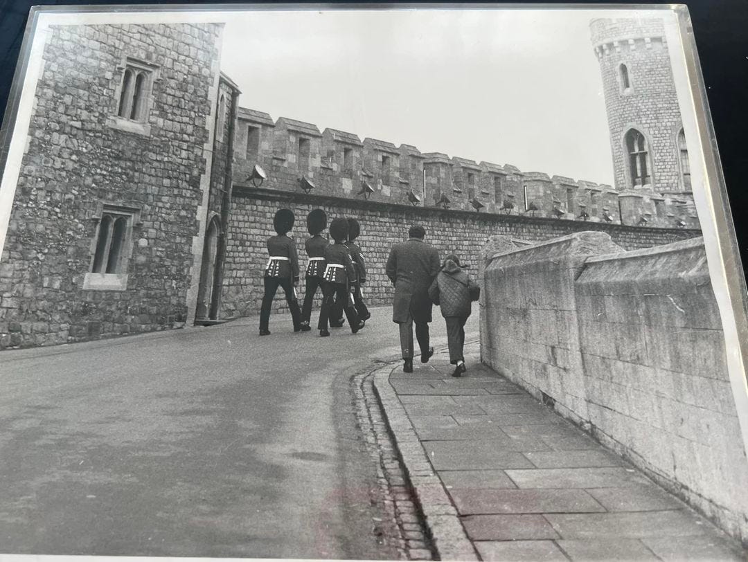 Sarah and her father marching with uniformed guards at Windsor Castle