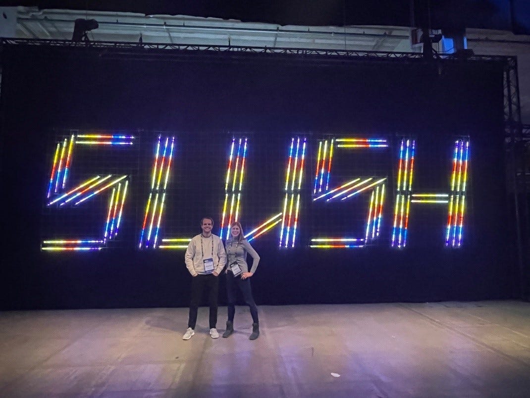 A person and person standing in front of a large screen with colorful lights

Description automatically generated with low confidence