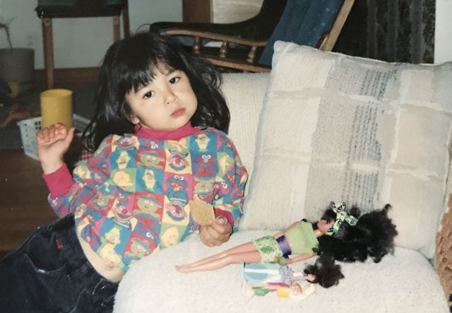 toddler mia honking on a cookie with her belly out