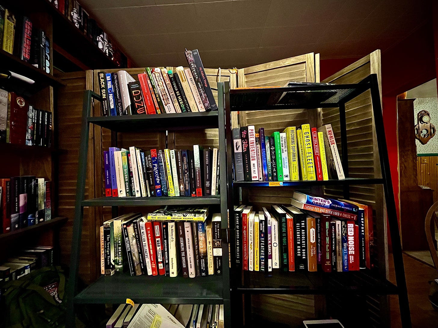 Two bookshelves, loaded down with colorful books. 