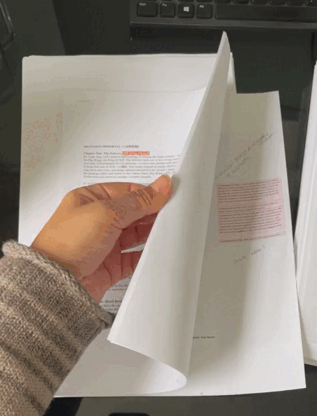 Flipping through a document filled with comment bubbles, track changes and hand written notes