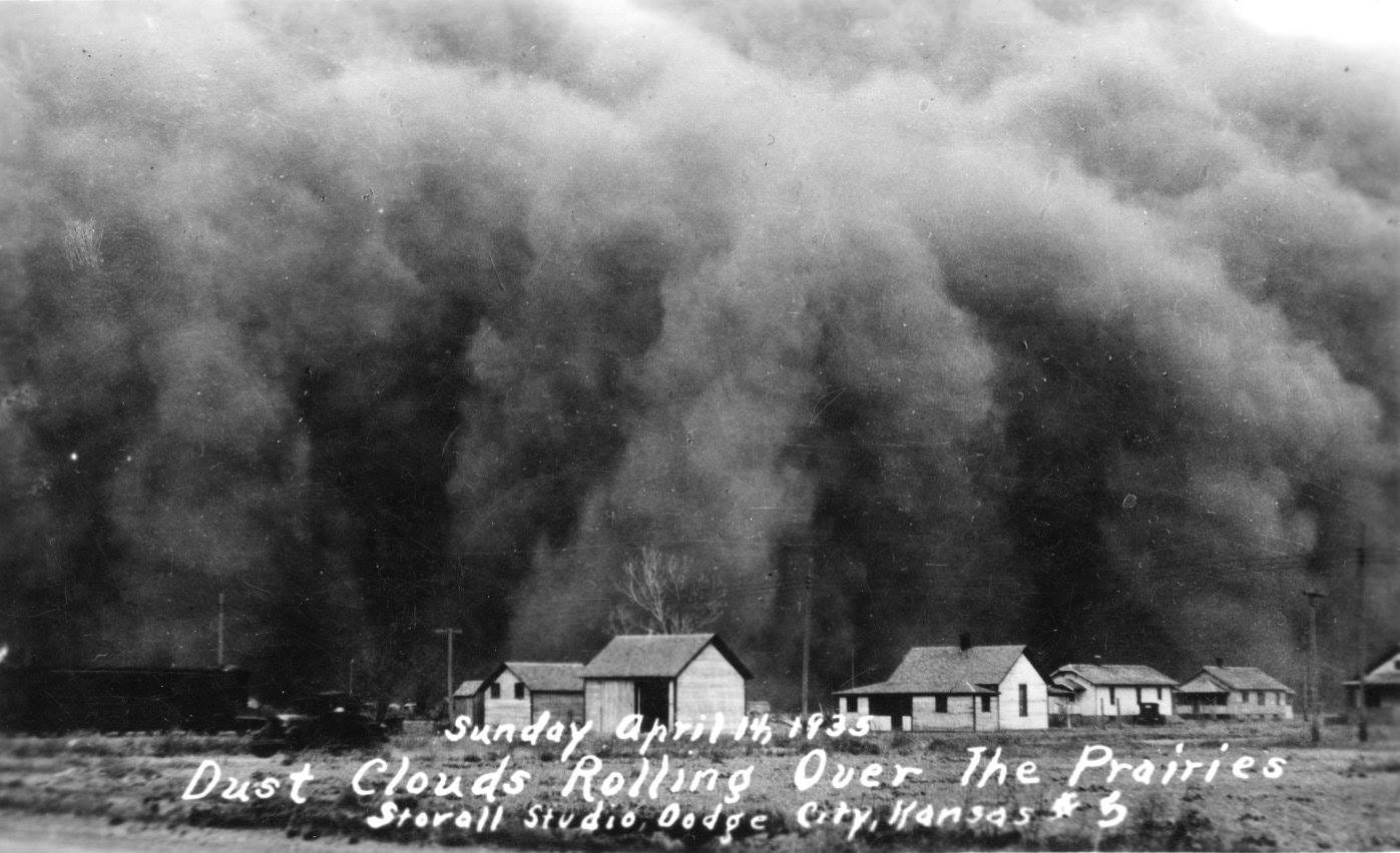 An old photograph of the dust storm that struck on Black Sunday, April the 14th 1935. The storm is quite dark and is beginning to consume the town of Dodge City, Kansas.