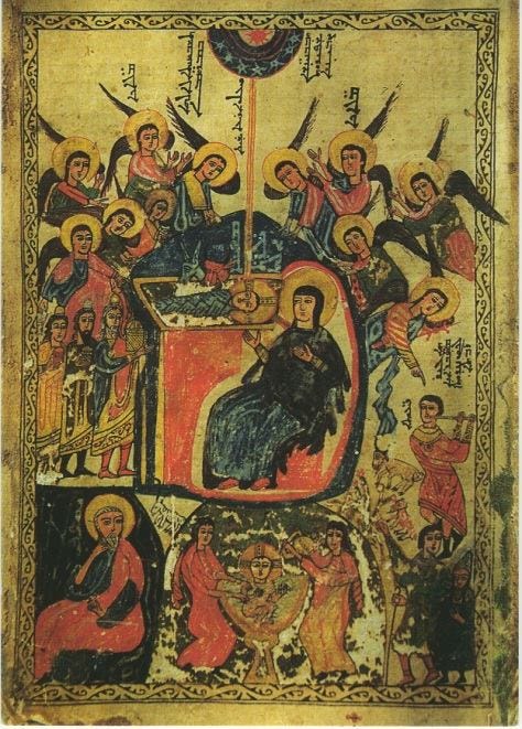 An image of the Mother of God and infant Christ surrounded by a choir of haloed angels. Mary is sitting up, nearly straight, and Christ is horizontal at her eye level. Various other scenes and actors from the Christmas story are visible around them - above, a sun in a disc surrounded by stars, cut off by the top edge of the page.