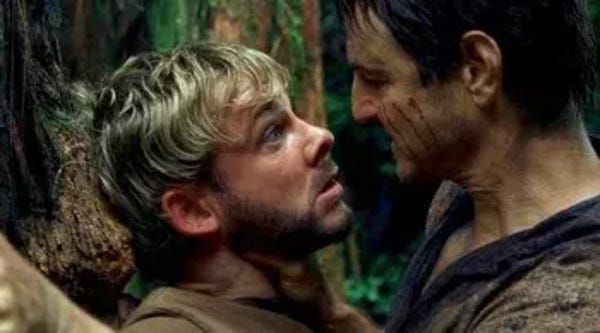 Charlie Pace (Dominic Monaghan) is accosted by Ethan Rom (William Mapother), who holds him pinned against a tree one-handed by the neck. Charlie wears a surprised and rather desperate look on his face, as if he is being choked by a murderous assailant.