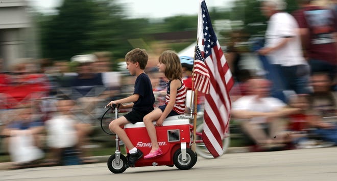 Youngsters ride a scooter in the City of Franklin Fourth of July Parade on Loomis Road Saturday, July 4, 2009, in Franklin.