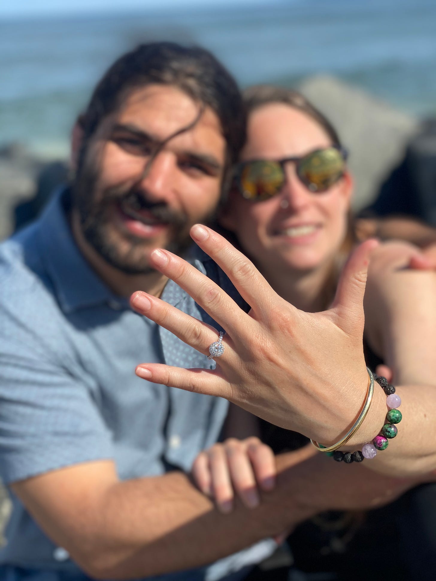 anthony and kelly pose engagement ring up
