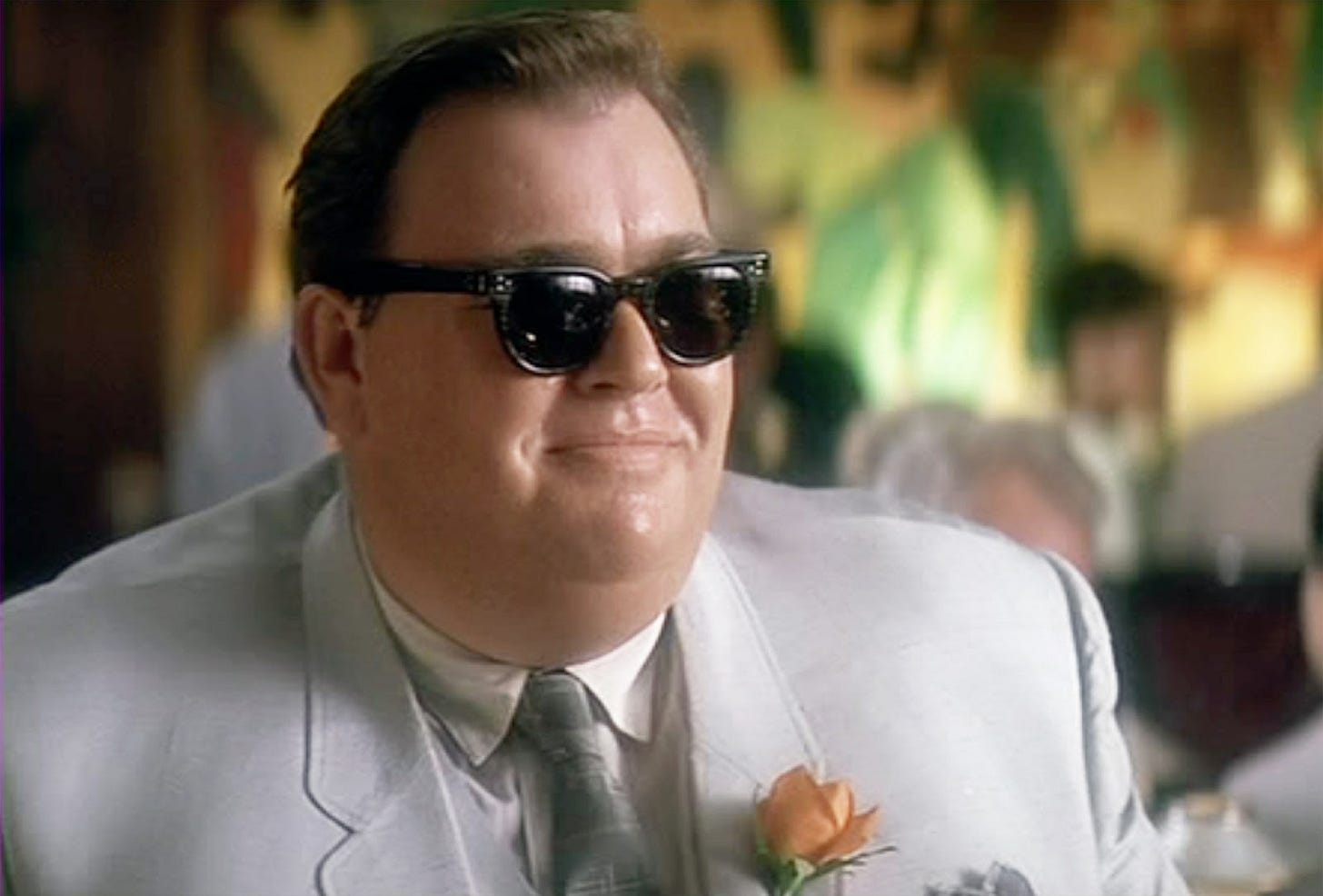 This image shows the character Dean Andrews (played by John Candy) in Oliver Stone's JFK.