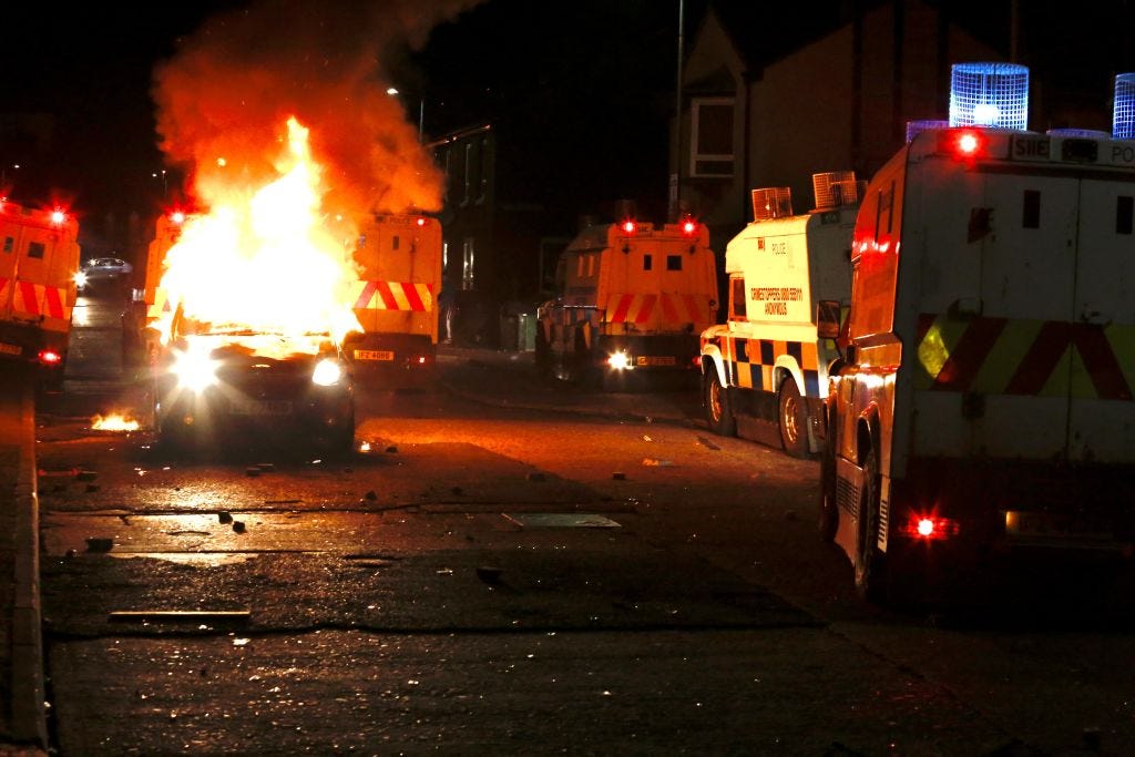Flames and smoke rise from car set a fire during protests as rioters hurled petrol bombs, fireworks and stones at police amid unrest since Wednesday, in Belfast, Northern Ireland on April 09, 2021. â¨The unrest started when some Sinn Fein members attended a crowded funeral on top of tensions caused by Brexit border arrangements, which brought checks on goods shipped between Northern Ireland and the rest of the UK. â¨Both loyalist and nationalist areas were involved in riots in west Belfast. (Photo by Hasan Esen/Anadolu Agency via Getty Images) Flames and smoke rise from car set a fire during protests as rioters hurled petrol bombs, fireworks and stones at police amid unrest since Wednesday, in Belfast, Northern Ireland on April 09, 2021. â¨The unrest started when some Sinn Fein members attended a crowded funeral on top of tensions caused by Brexit border arrangements, which brought checks on goods shipped between Northern Ireland and the rest of the UK. â¨Both loyalist and nationalist areas were involved in riots in west Belfast. (Photo by Hasan Esen/Anadolu Agency via Getty Images)